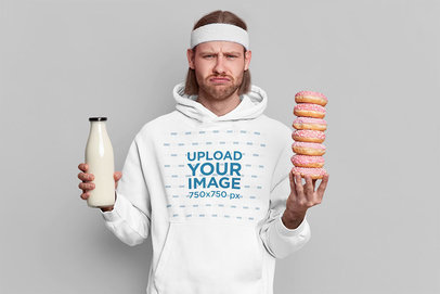 Hoodie Mockup of a Disappointed Man Holding Some Donuts m3729-r-el2