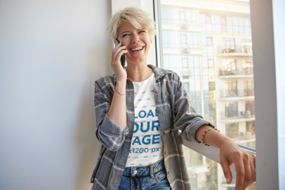 T-Shirt Mockup of a Woman Making a Call by a Window 