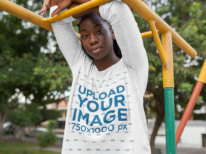 Mockup of a Woman Wearing a Bella Flowie Long Sleeve Off Shoulder Tee While at the Park 