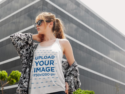 Pretty Girl Wearing a Bella Canvas Tank Top Mockup While Walking Near a Big Building a16120