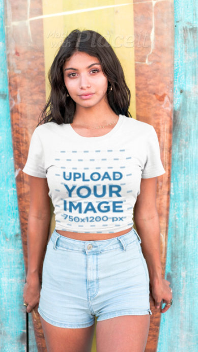 T-Shirt Video of a  Woman Standing Against a Surfboard