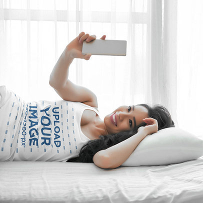 Tank Top Mockup of a Woman Lying on Her Bed with a Cellphone