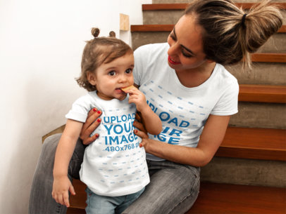 Baby Girl Eating a Cookie While with her Mom Wearing T-Shirts Mockup