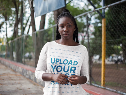 Front Shot Mockup of a Black Girl with Dreadlocks Wearing a Heather Long Sleeve Tee Mockup While in a Basketball Court a16199