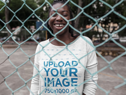 Smiling Black Girl with Dreadlocks Wearing a Long Sleeve Heather T-Shirt Mockup While Near a Fence Outdoors a16208