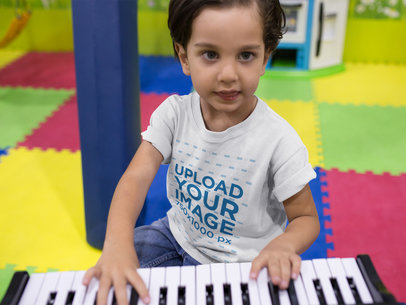 Kid Playing the Piano While Wearing a Round Neck Tee Mockup