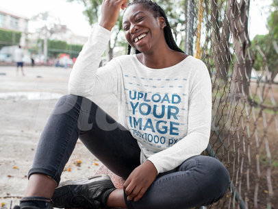 Black Girl with Dreadlocks Wearing a Bella Flowie Long Sleeve Off Neck Tee Template While Laughing in an Urban Area a16200