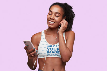 Sublimated Sports Bra Mockup of a Woman Listening to Music in a Studio