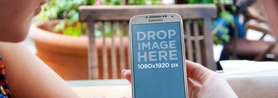 Wide Mockup of a Galaxy Phone Featuring Two Friends at a Restaurant