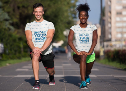 Sublimated T-Shirt Mockup of a Fitness Couple Stretching Their Legs
