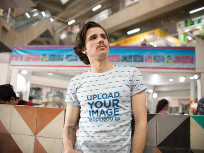 Mockup of a Young Guy with Moustache and a Tattoo Weairng a Sublimated Tee While inside a Urban Market a15356