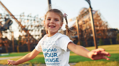 Mockup of a Girl in a T-Shirt at an Amusement Park 