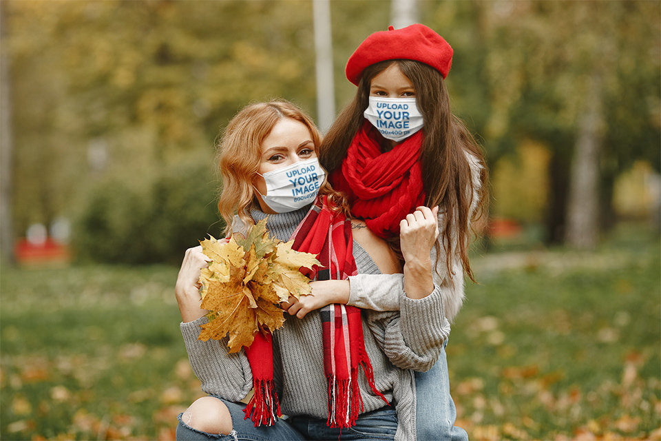 Face Mask Mockup Featuring a Woman and Her Daughter in an Outdoor Fall Setting