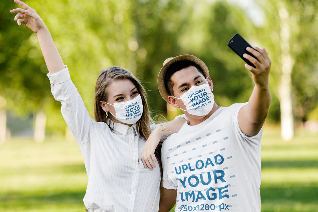 Tee and Face Mask Mockup Featuring a Happy Couple Taking a Selfie at the Park