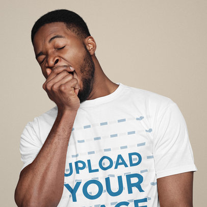 T-Shirt Mockup Featuring a Man Snoozing at a Studio
