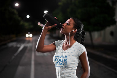 T-Shirt Mockup of an Athlete Drinking Water After Her Nocturnal Run