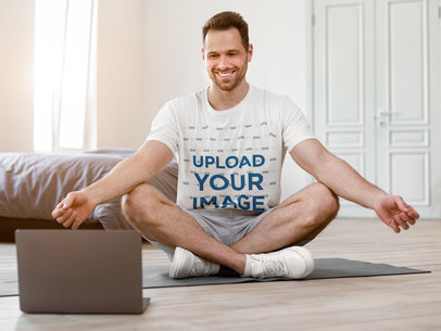 T-Shirt Mockup of a Smiling Man Taking a Virtual Yoga Class