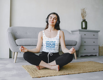 Tank Top Mockup of a Woman Meditating with Headphones at Home