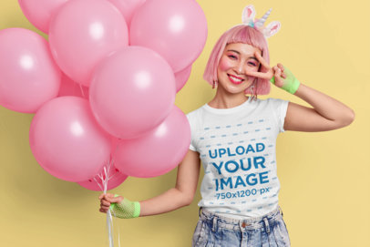 T-Shirt Mockup Featuring a Happy Woman With a Pink Hairstyle Holding Balloons