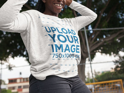 Mockup of a Woman Wearing a Long Sleeve Heather Tee While at the Park 16205