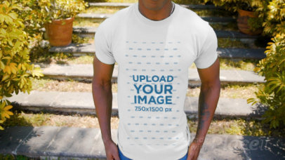 T-Shirt Video of a Man with an Arm Tattoo Walking in an Urban Setting