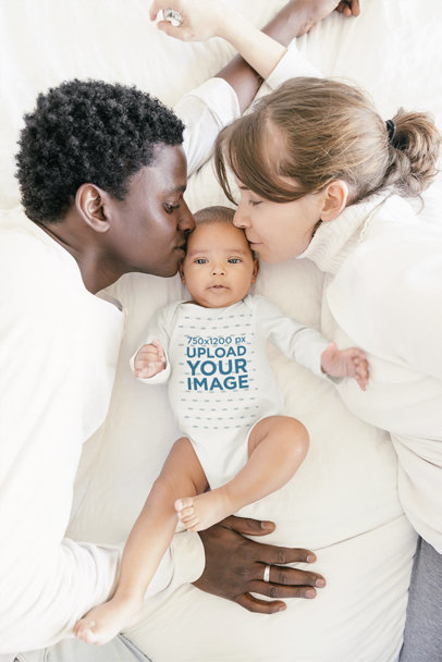 Onesie Mockup Featuring a Baby Being Kissed by His Parents
