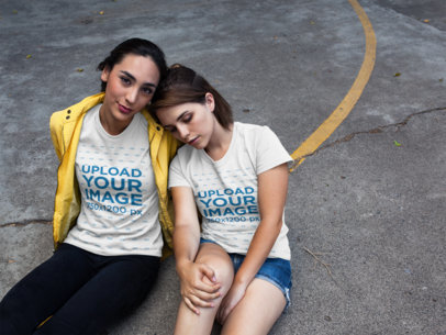 Girlfriends Wearing Different Round Neck Tees Mockup While Sitting Down in a Basketball Court