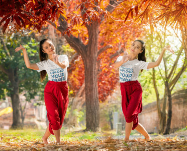 V-Neck Tee Mockup Featuring Two Women Posing Under a Brown-Leaf Tree M9894-r-el2