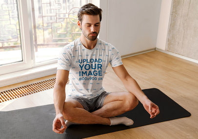 Sublimated T-Shirt Mockup of a Man Meditating at Home