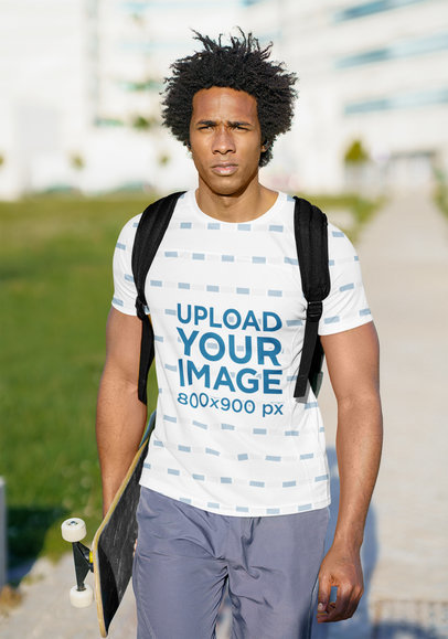 Round-Neck Tee Mockup of a Man with a Backpack Holding a Skateboard