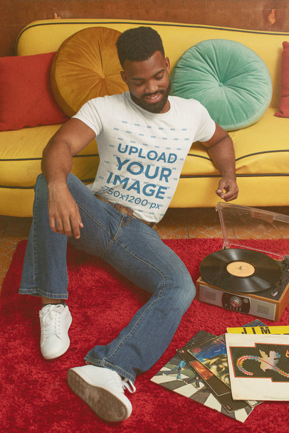 T-Shirt Mockup of a Man Listening to a Record with a 70's Aesthetic