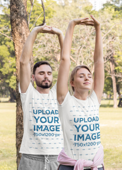 T-Shirt Mockup of a Couple Stretching Their Arms at a Park
