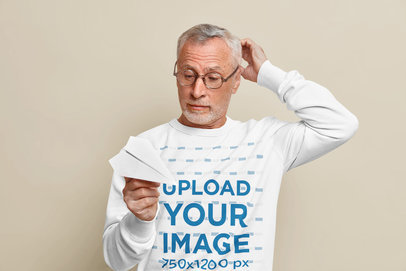 Sweatshirt Mockup Featuring a Senior Man Holding a Paper Plane m9551-r-el2