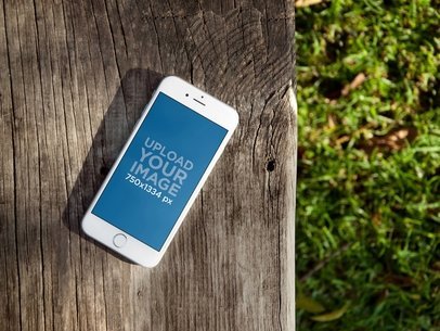 White Apple iPhone 7 mockup on wooden bench