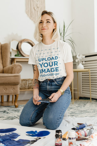 T-Shirt Mockup Featuring a Happy Tattooed Woman Painting