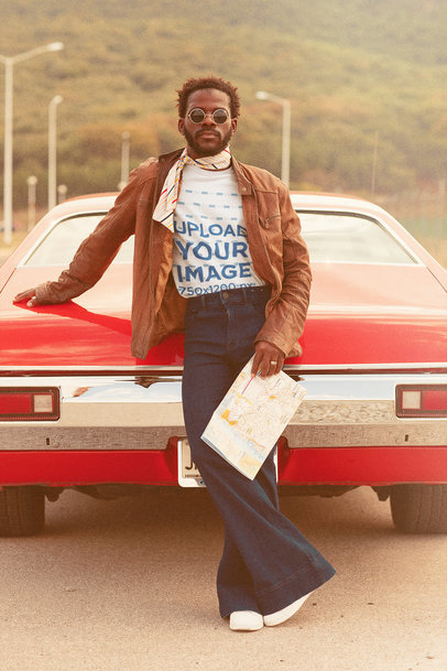 T-Shirt Mockup of a Man Holding a Road Map by a Classical Car m10490