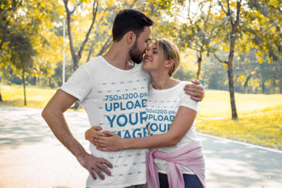 Rounded-Neck T-Shirt Mockup of a Couple Hugging at a Park