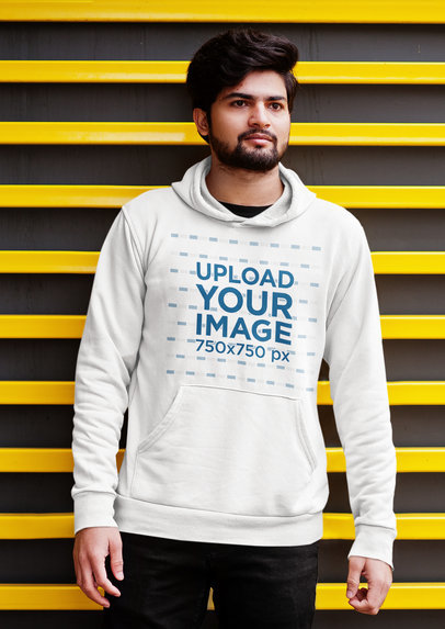 Pullover Hoodie Mockup of a Bearded Man Posing in Front of a Striped Wall