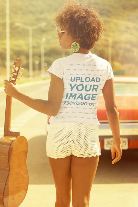 T-Shirt Mockup of a Guitar Player Walking Towards a Vintage Car
