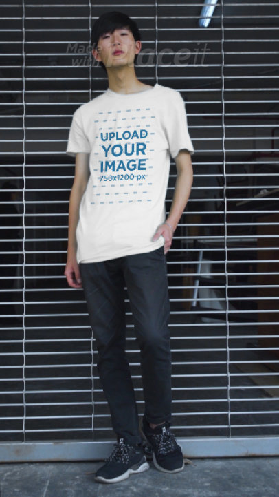 T-Shirt Video Featuring a Man Posing Against a Fence 