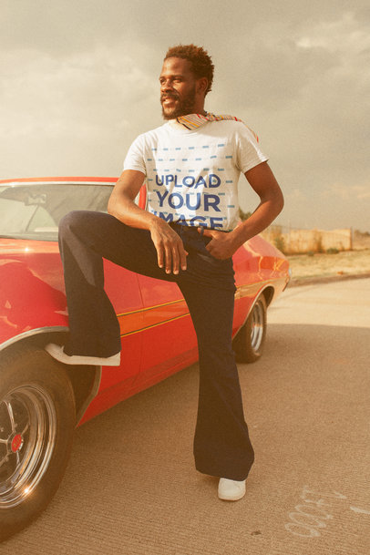 T-Shirt Mockup of a Man Posing by a Classic Car