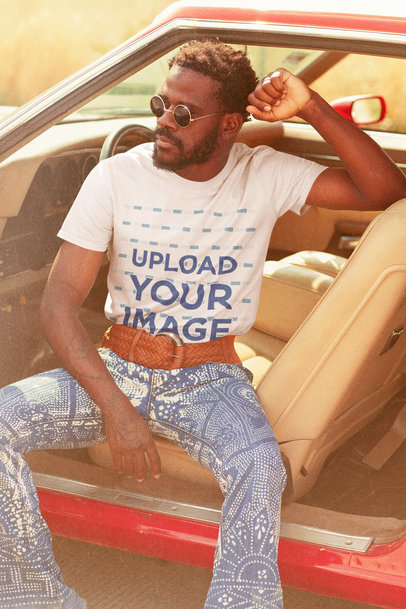 Retro Mockup of a Man Wearing a T-Shirt While Posing in a Classic Car
