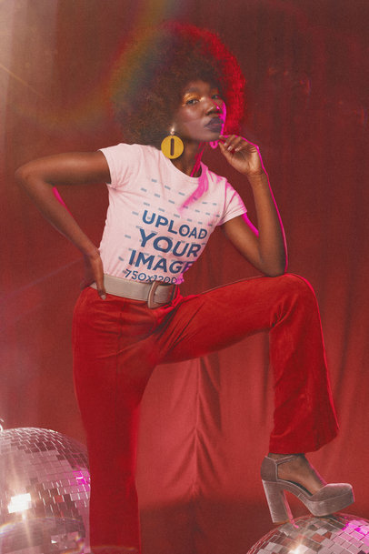 T-Shirt Mockup of a Curly-Haired Woman in a 70s Outfit Posing By Some Disco Balls m10146