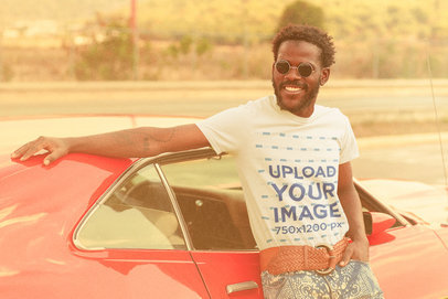 T-Shirt Mockup of a Man Posing With an Old Car