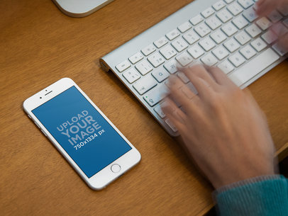 Mockup of an iPhone 6 on a Computer Desk