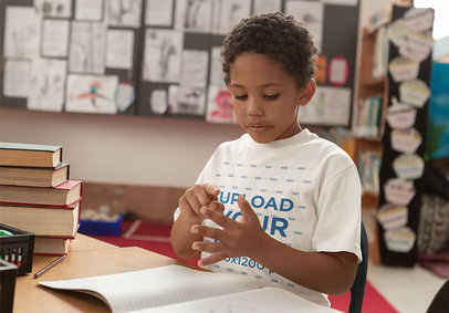 T-Shirt Mockup Featuring a Serious Boy at School