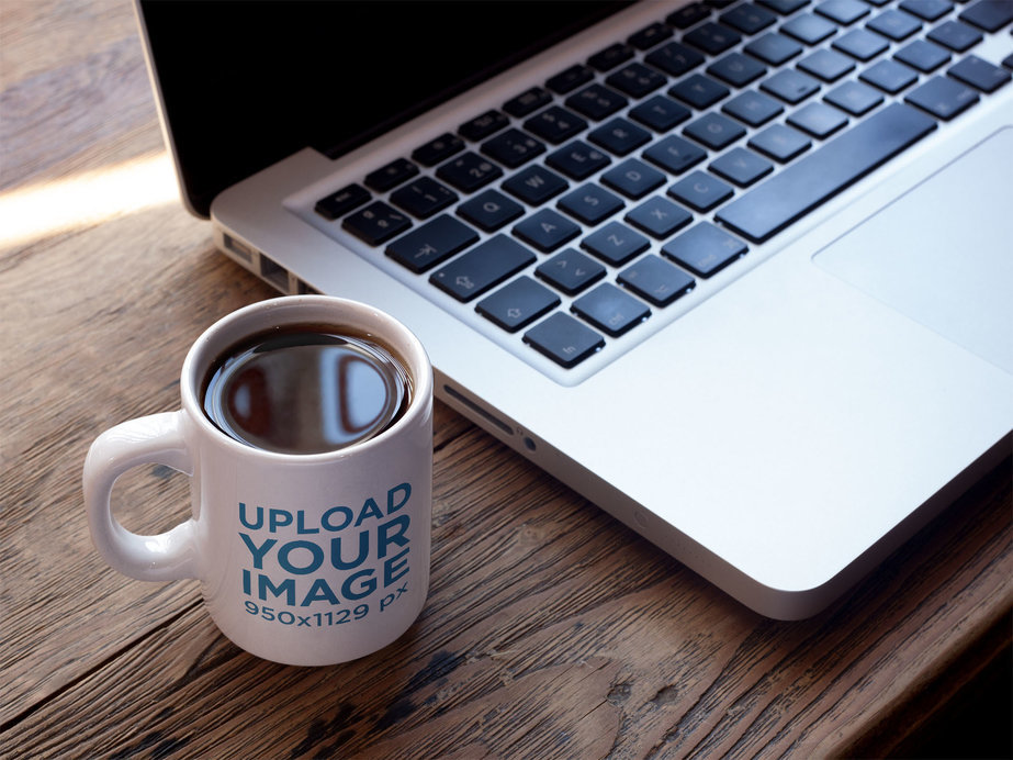 Cup of Coffee Mockup Near a MacBook