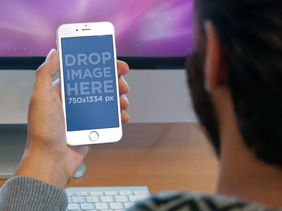 Mockup of a White iPhone Being Used at Work by a Man