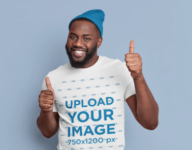 T-Shirt Mockup Featuring a Happy Man Giving Thumbs-Up in a Studio