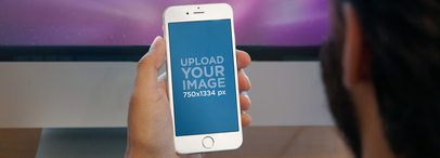 Mockup of a White iPhone 6 Being Used At Work